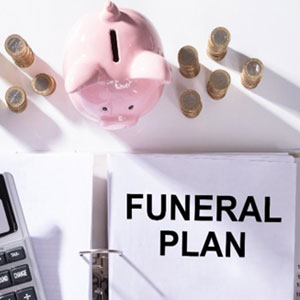 Funeral plan for a loved one: A serene setting with flowers, a casket, and mourners paying their respects.