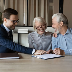 Attorney meeting with senior couple to review estate plan before Florida tax season